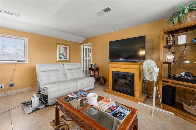 living room with vaulted ceiling and tile patterned flooring