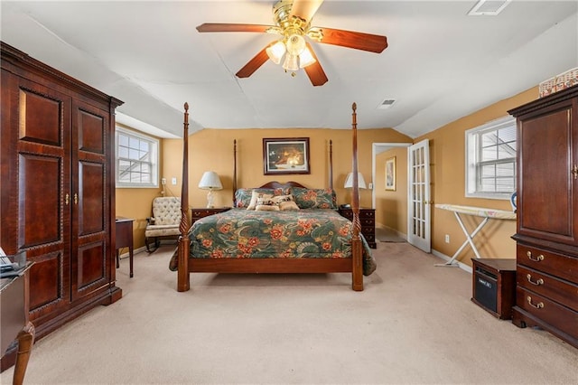 carpeted bedroom with french doors, ceiling fan, lofted ceiling, and multiple windows