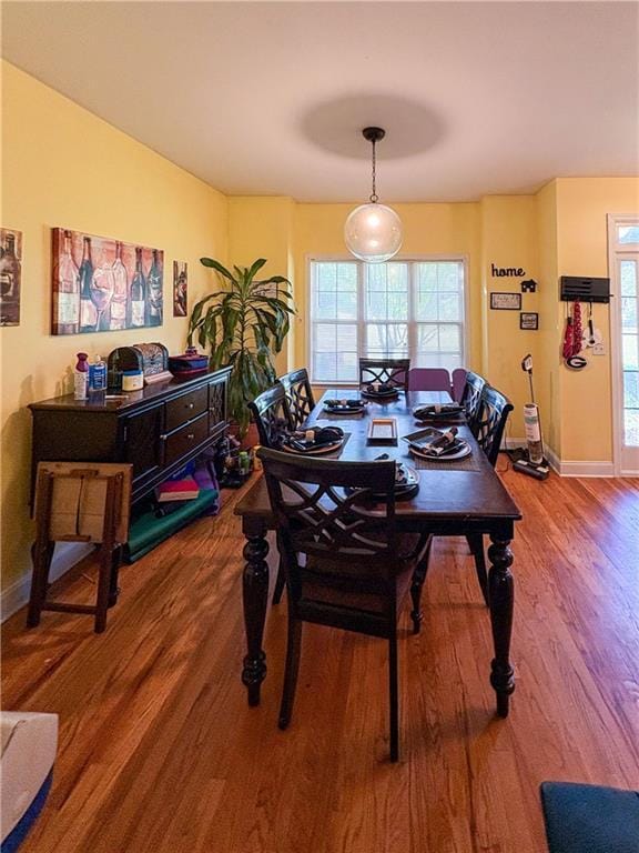 dining room featuring baseboards and wood finished floors