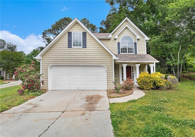 traditional home with a porch, driveway, a front yard, and a garage