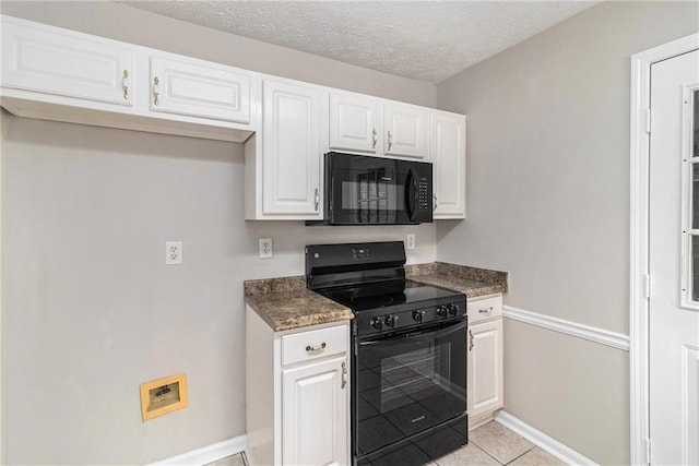kitchen with dark countertops, baseboards, white cabinetry, light tile patterned floors, and black appliances