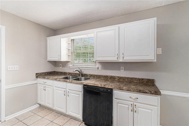 kitchen with dark countertops, baseboards, white cabinetry, a sink, and dishwasher