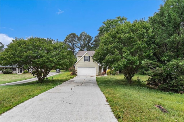 view of front of property featuring concrete driveway, a front yard, and a garage