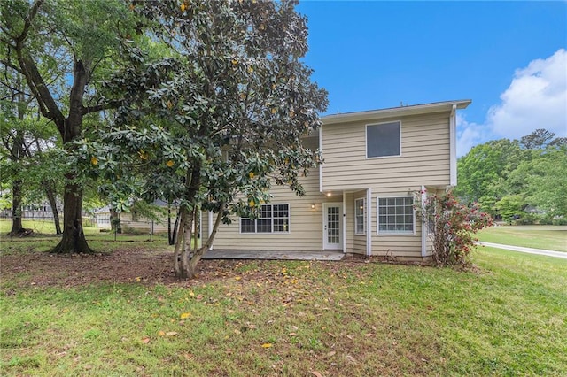 view of front of house featuring a patio, a front lawn, and fence