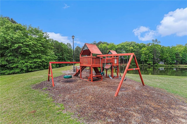 view of jungle gym featuring a lawn and a water view