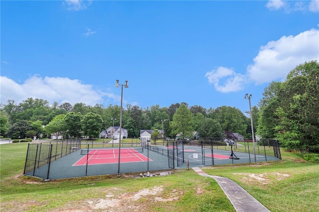 view of sport court featuring a yard, a tennis court, fence, and community basketball court