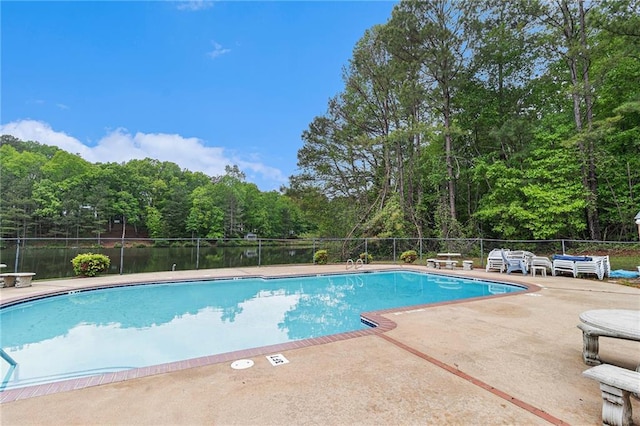 pool featuring fence and a patio area