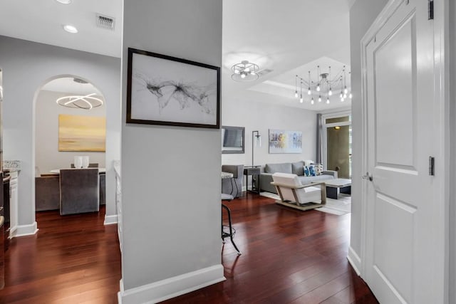 325 E Paces Ferry Rd NE Unit 1910, Atlanta, GA 30305 - hallway featuring a chandelier, hardwood / wood-style flooring, arched walkways, a tray ceiling, and recessed lighting