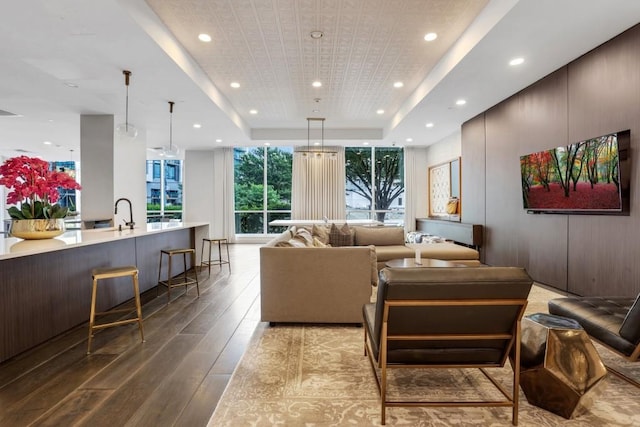325 E Paces Ferry Rd NE Unit 1910, Atlanta, GA 30305 - living room featuring a tray ceiling, recessed lighting, wood-type flooring, and expansive windows