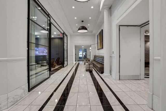 325 E Paces Ferry Rd NE Unit 1910, Atlanta, GA 30305 - hallway with a raised ceiling, inlaid floor details, recessed lighting, ornamental molding, and decorative columns