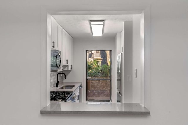 interior space with a textured ceiling and a sink