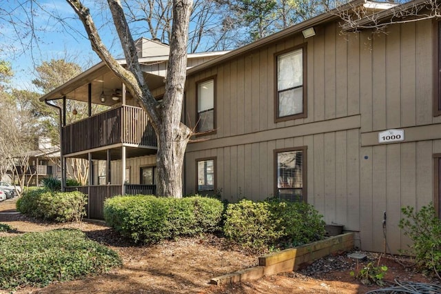 view of home's exterior with a balcony and a ceiling fan