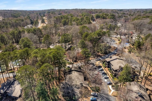 birds eye view of property featuring a view of trees