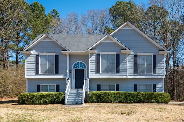 bi-level home with a front lawn