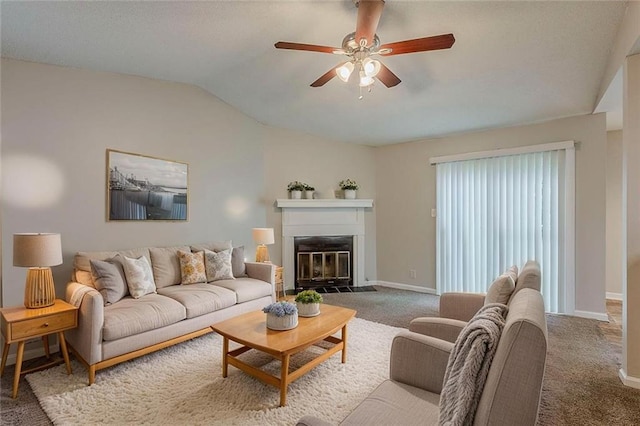 6200 Beaver Creek Trl, Atlanta, GA 30349 - carpeted living room with ceiling fan, a glass covered fireplace, and vaulted ceiling