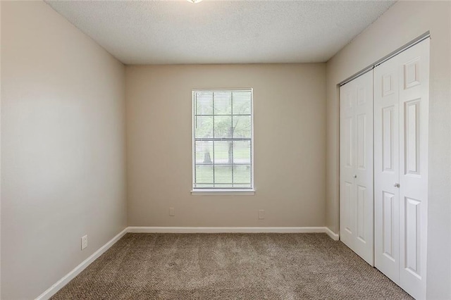 6200 Beaver Creek Trl, Atlanta, GA 30349 - unfurnished bedroom with carpet flooring, a closet, and a textured ceiling