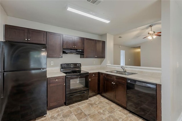 6200 Beaver Creek Trl, Atlanta, GA 30349 - kitchen with black appliances, under cabinet range hood, dark brown cabinetry, and light countertops