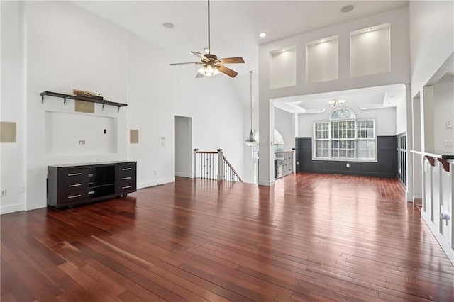 4046 Water Hole Ct, Douglasville, GA 30135 - unfurnished living room featuring a towering ceiling, a ceiling fan, and hardwood / wood-style floors