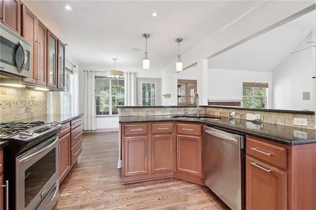4046 Water Hole Ct, Douglasville, GA 30135 - kitchen with appliances with stainless steel finishes, backsplash, light wood-style floors, dark stone counters, and recessed lighting