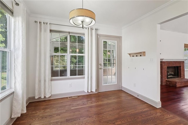 4046 Water Hole Ct, Douglasville, GA 30135 - unfurnished dining area with wood finished floors, ornamental molding, plenty of natural light, and a fireplace