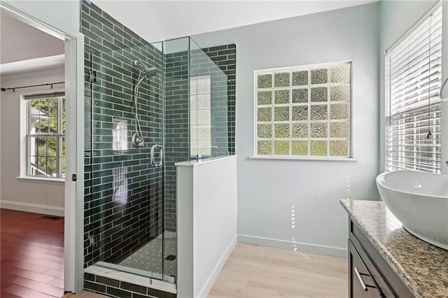 4046 Water Hole Ct, Douglasville, GA 30135 - bathroom featuring wood finished floors, a shower stall, and vanity