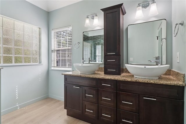 4046 Water Hole Ct, Douglasville, GA 30135 - full bathroom featuring wood finished floors and double vanity