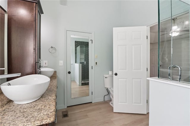 4046 Water Hole Ct, Douglasville, GA 30135 - full bath with wood finished floors, double vanity, and a shower stall