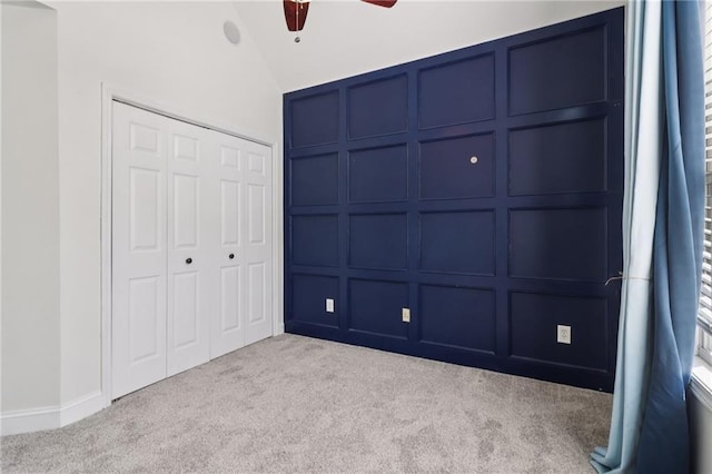 4046 Water Hole Ct, Douglasville, GA 30135 - unfurnished bedroom with carpet floors, a decorative wall, a closet, lofted ceiling, and a ceiling fan