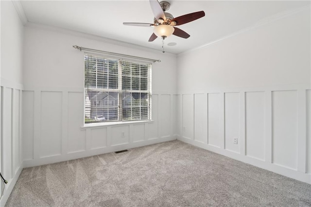 4046 Water Hole Ct, Douglasville, GA 30135 - empty room featuring a decorative wall, carpet flooring, a ceiling fan, a wainscoted wall, and crown molding