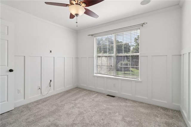 4046 Water Hole Ct, Douglasville, GA 30135 - carpeted empty room featuring a decorative wall, ornamental molding, a ceiling fan, and wainscoting