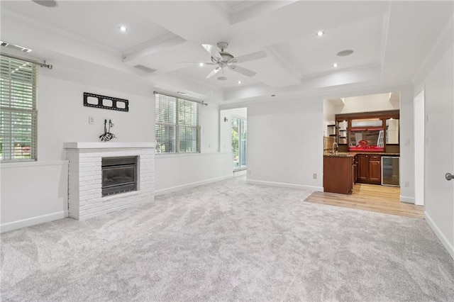 4046 Water Hole Ct, Douglasville, GA 30135 - unfurnished living room with wine cooler, light colored carpet, a ceiling fan, coffered ceiling, and a fireplace