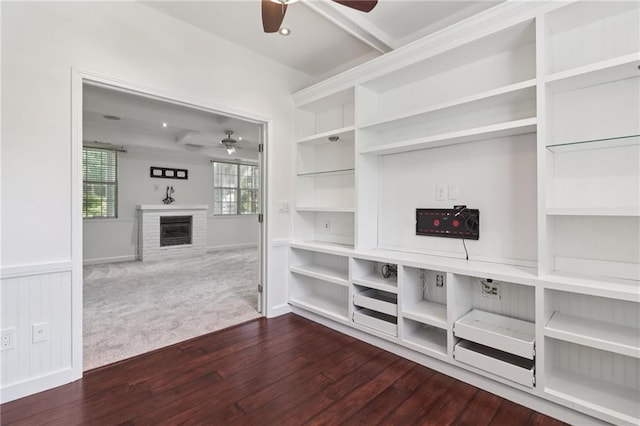 4046 Water Hole Ct, Douglasville, GA 30135 - unfurnished living room with ceiling fan, a glass covered fireplace, and wood finished floors