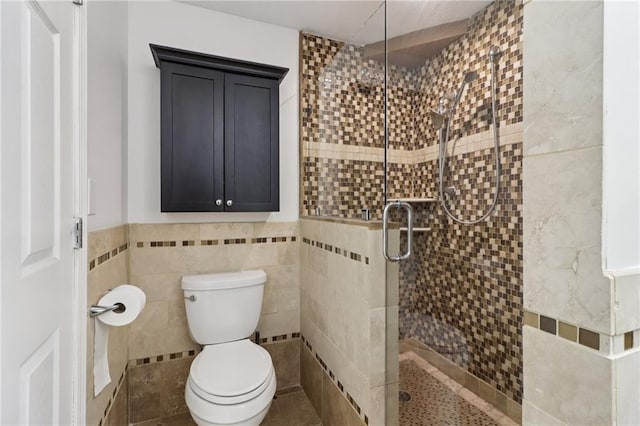 4046 Water Hole Ct, Douglasville, GA 30135 - bathroom with tile walls, a stall shower, and wainscoting