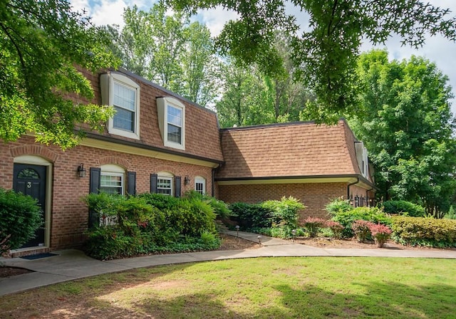 1261 Lavista Rd Unit N4, Atlanta, GA 30324 - view of front of home featuring mansard roof, roof with shingles, brick siding, and a front yard