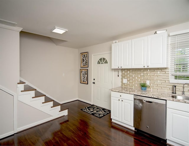 1261 Lavista Rd Unit N4, Atlanta, GA 30324 - kitchen with dishwasher, dark wood-type flooring, backsplash, and white cabinetry