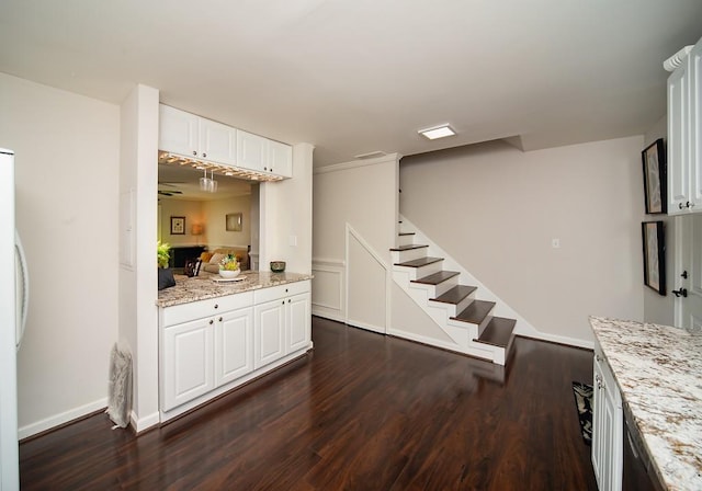 1261 Lavista Rd Unit N4, Atlanta, GA 30324 - kitchen with dark wood-style floors, white cabinets, light stone countertops, and baseboards