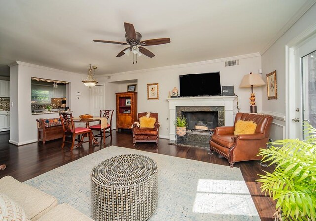1261 Lavista Rd Unit N4, Atlanta, GA 30324 - living room with dark wood-type flooring, a ceiling fan, a tiled fireplace, and ornamental molding