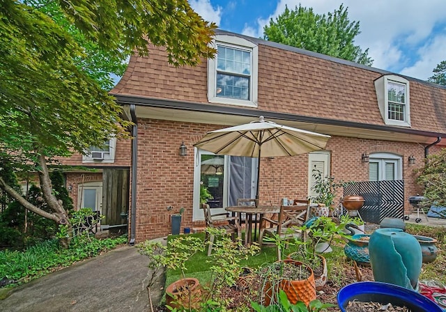 1261 Lavista Rd Unit N4, Atlanta, GA 30324 - rear view of house with a shingled roof, mansard roof, and brick siding