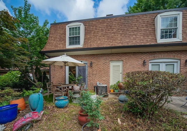 1261 Lavista Rd Unit N4, Atlanta, GA 30324 - rear view of property featuring roof with shingles, mansard roof, and brick siding