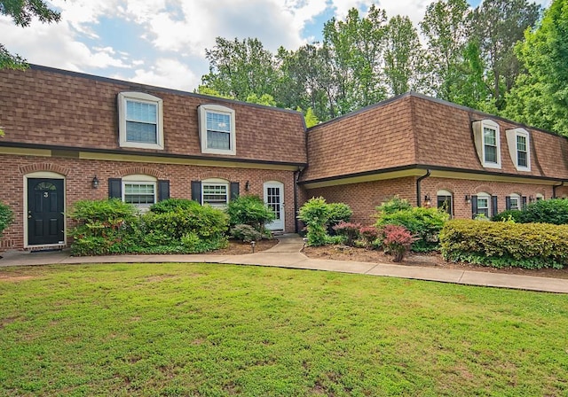 1261 Lavista Rd Unit N4, Atlanta, GA 30324 - view of front of house featuring mansard roof, roof with shingles, brick siding, and a front yard
