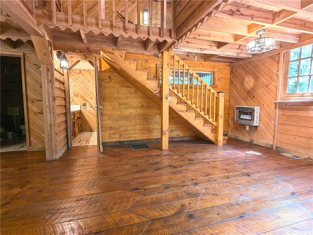 176 Petunia Dr, Dahlonega, GA 30533 - unfurnished living room with wooden walls, hardwood / wood-style floors, heating unit, stairway, and beamed ceiling
