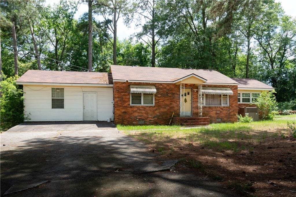 ranch-style home featuring central air condition unit