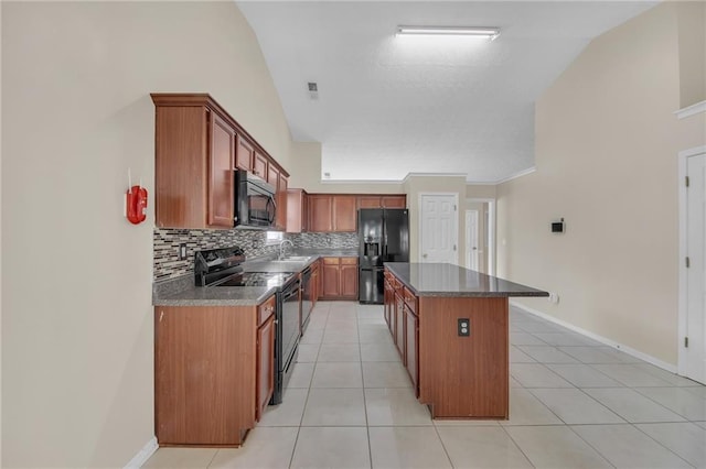 70 Prince Edward Way, Covington, GA 30016 - kitchen with black appliances, lofted ceiling, decorative backsplash, a center island, and light tile patterned floors