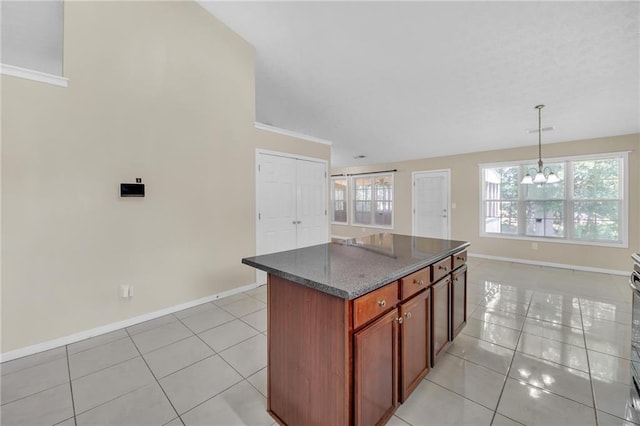 70 Prince Edward Way, Covington, GA 30016 - kitchen with light tile patterned floors, a chandelier, a kitchen island, hanging light fixtures, and vaulted ceiling