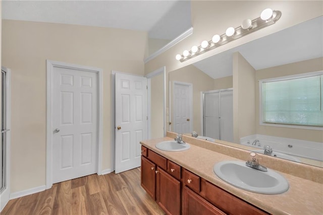 70 Prince Edward Way, Covington, GA 30016 - full bathroom with a stall shower, wood finished floors, double vanity, and a garden tub