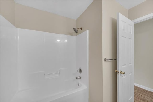 70 Prince Edward Way, Covington, GA 30016 - bathroom with washtub / shower combination and wood finished floors