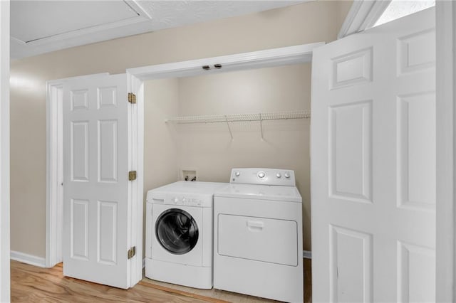 70 Prince Edward Way, Covington, GA 30016 - laundry room with washing machine and clothes dryer and light wood-type flooring
