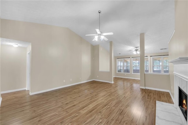 70 Prince Edward Way, Covington, GA 30016 - unfurnished living room featuring ceiling fan, a premium fireplace, light wood-style flooring, and vaulted ceiling