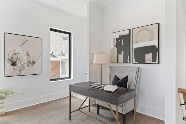 office space with baseboards and wood finished floors