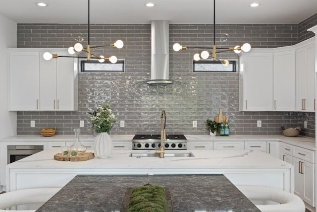 kitchen with recessed lighting, decorative backsplash, wall chimney exhaust hood, and white cabinets